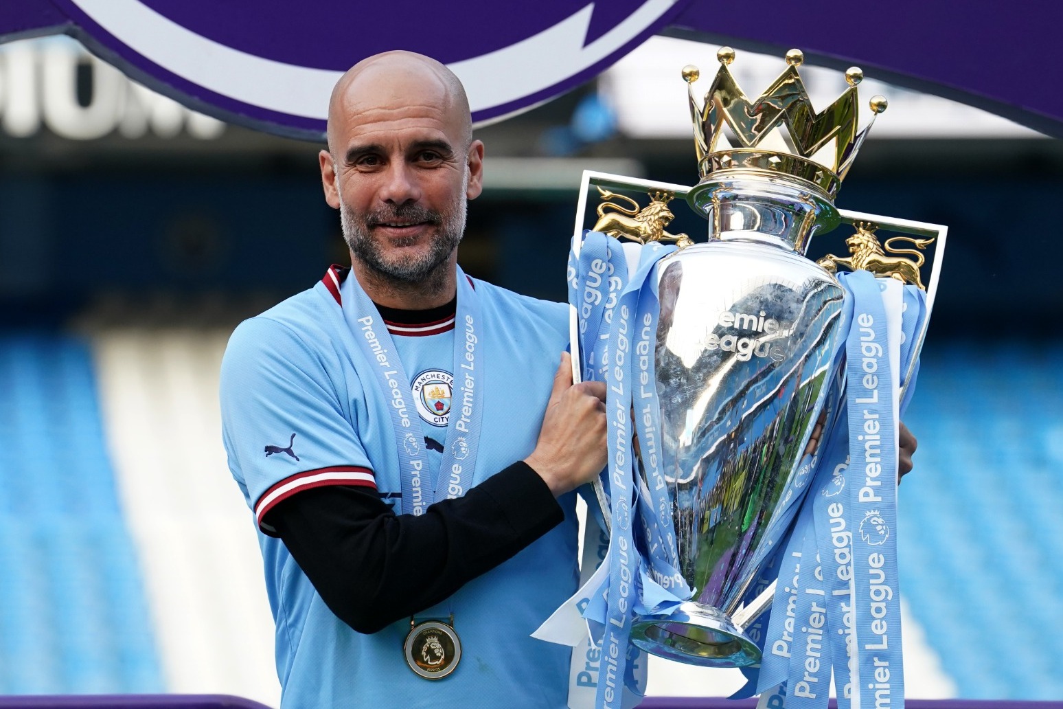 Manchester City players and fans celebrate step one of the treble