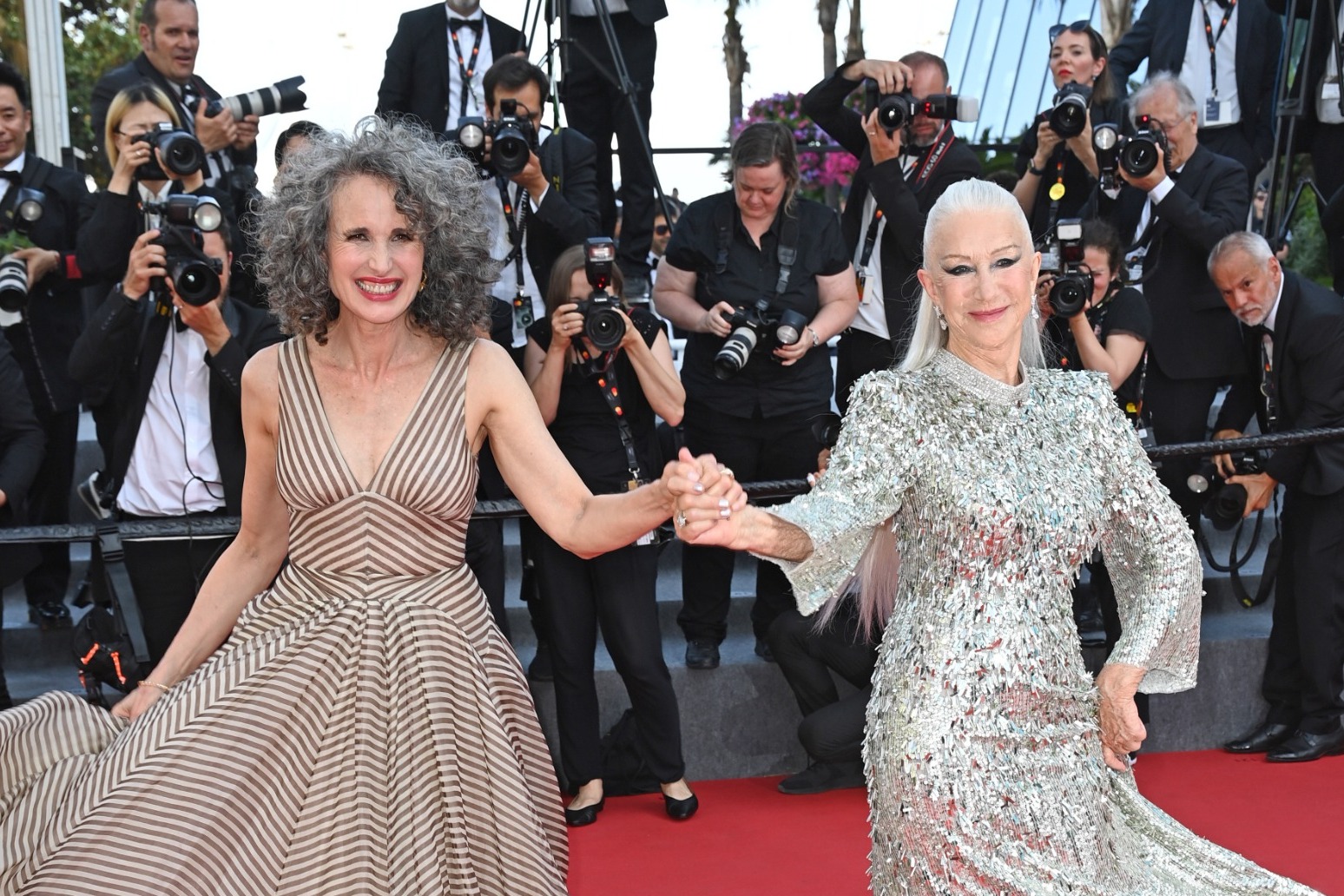 Dame Helen Mirren and Andie MacDowell dance down Cannes red carpet