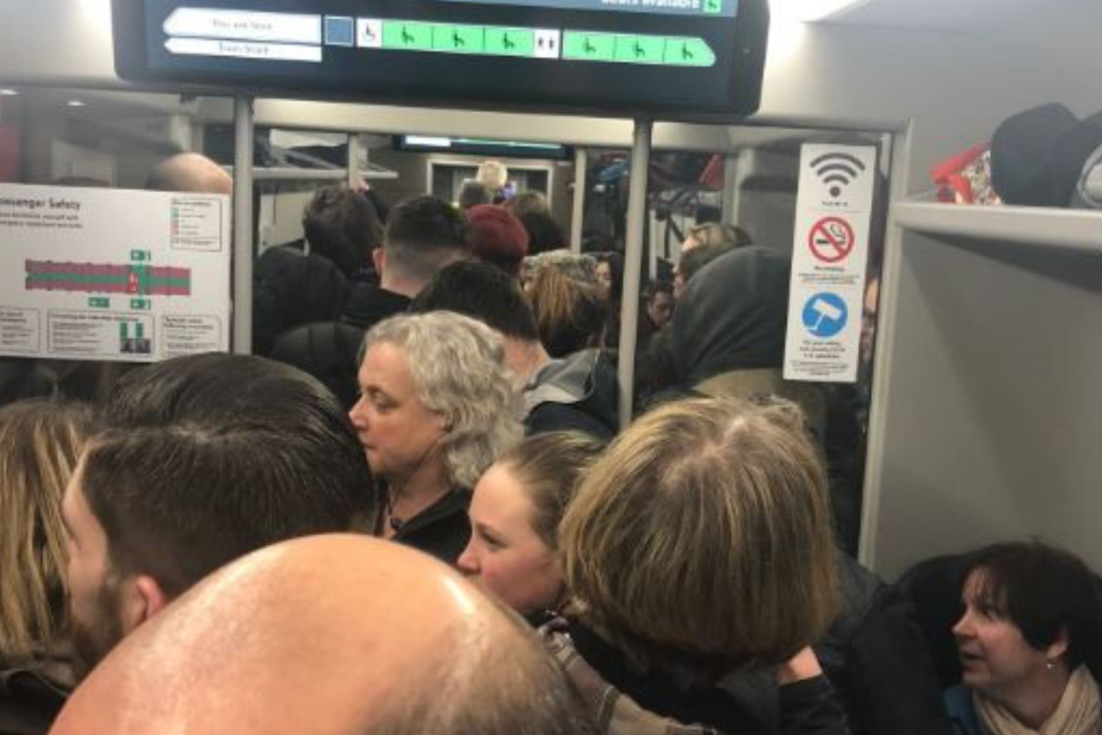 Train passengers cram into